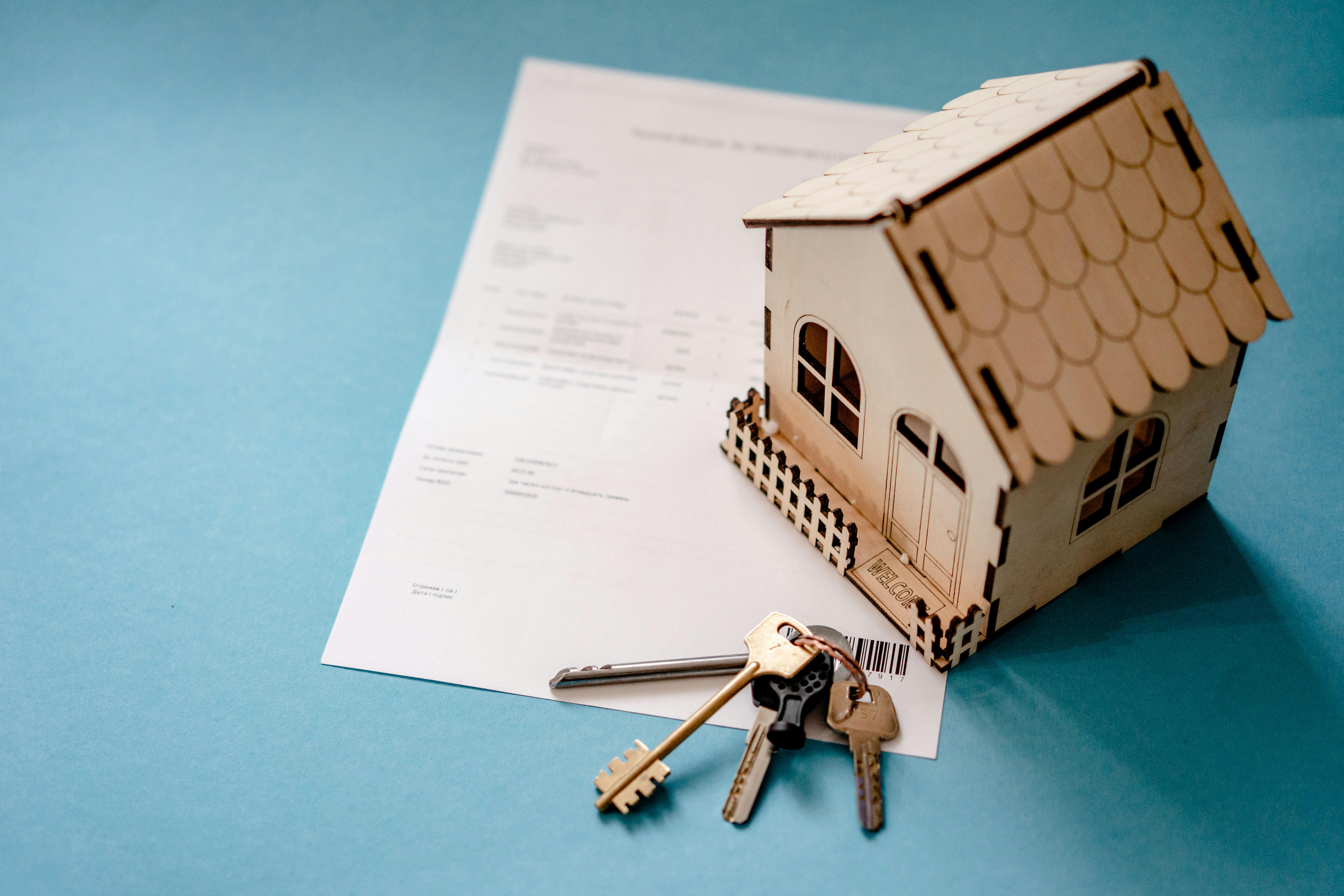 Photo by Atlantic Ambience: https://www.pexels.com/photo/wooden-house-moder-keys-and-contract-on-table-12955837/